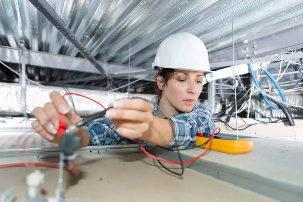 female electrician working on wiring